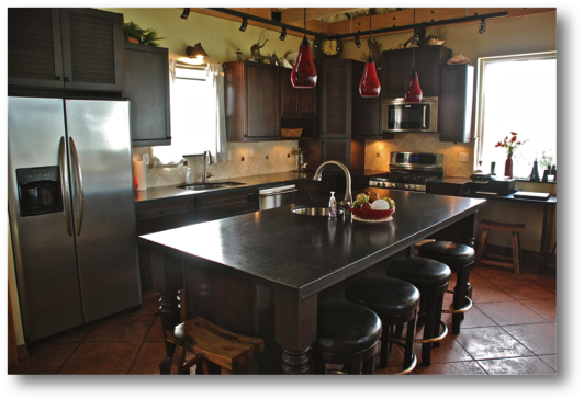 Kitchen with high end appliances, bar stools and everything you need for making and enjoying your meals